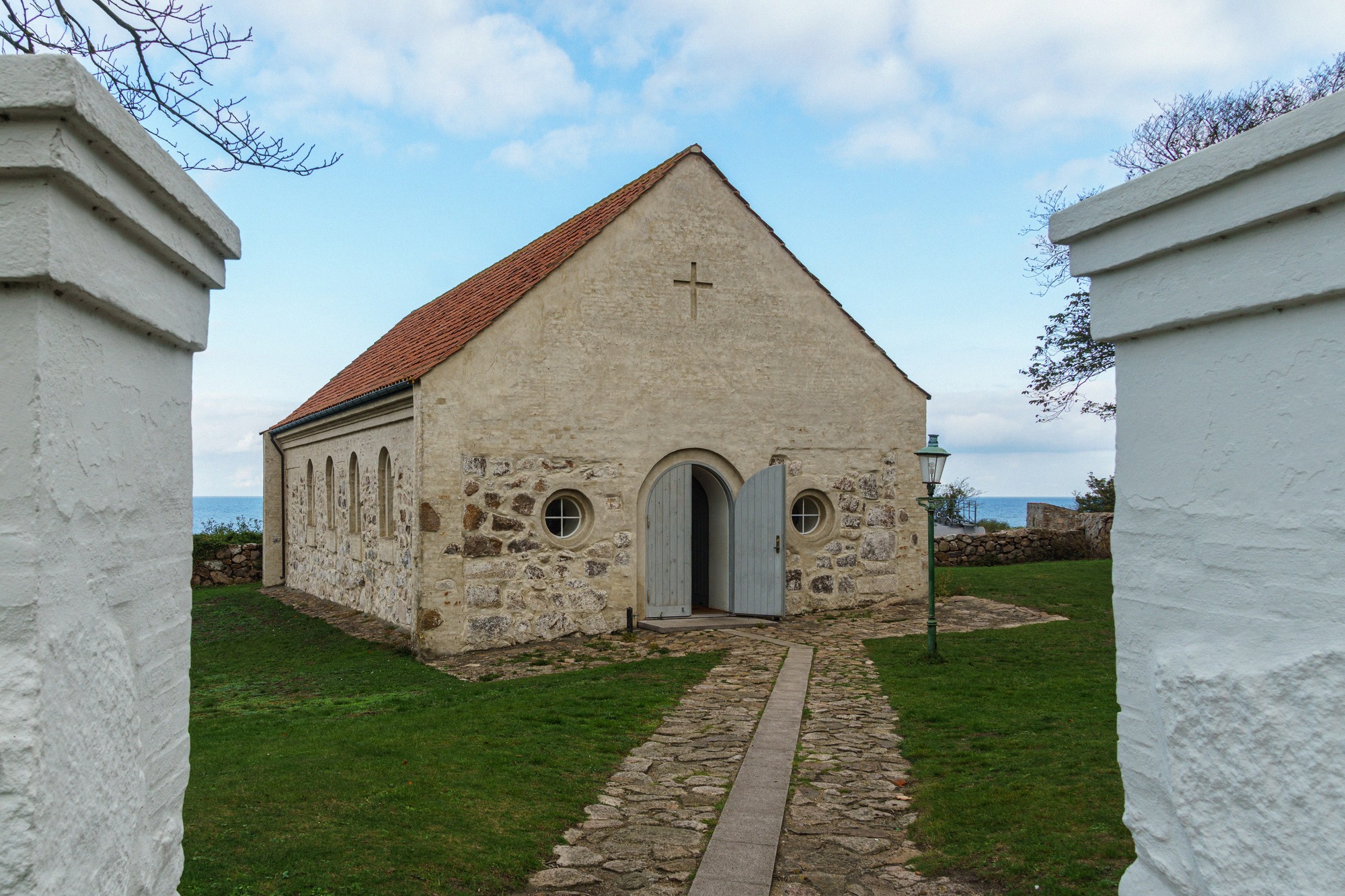 Christiansø's small chapel, once a weapons forge. Small stone chapel on Christiansø with a red tile roof and a view of the sea